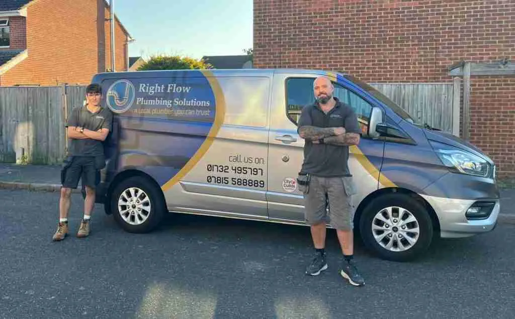 Two Right Flow Plumbing Solutions engineers standing beside their branded van